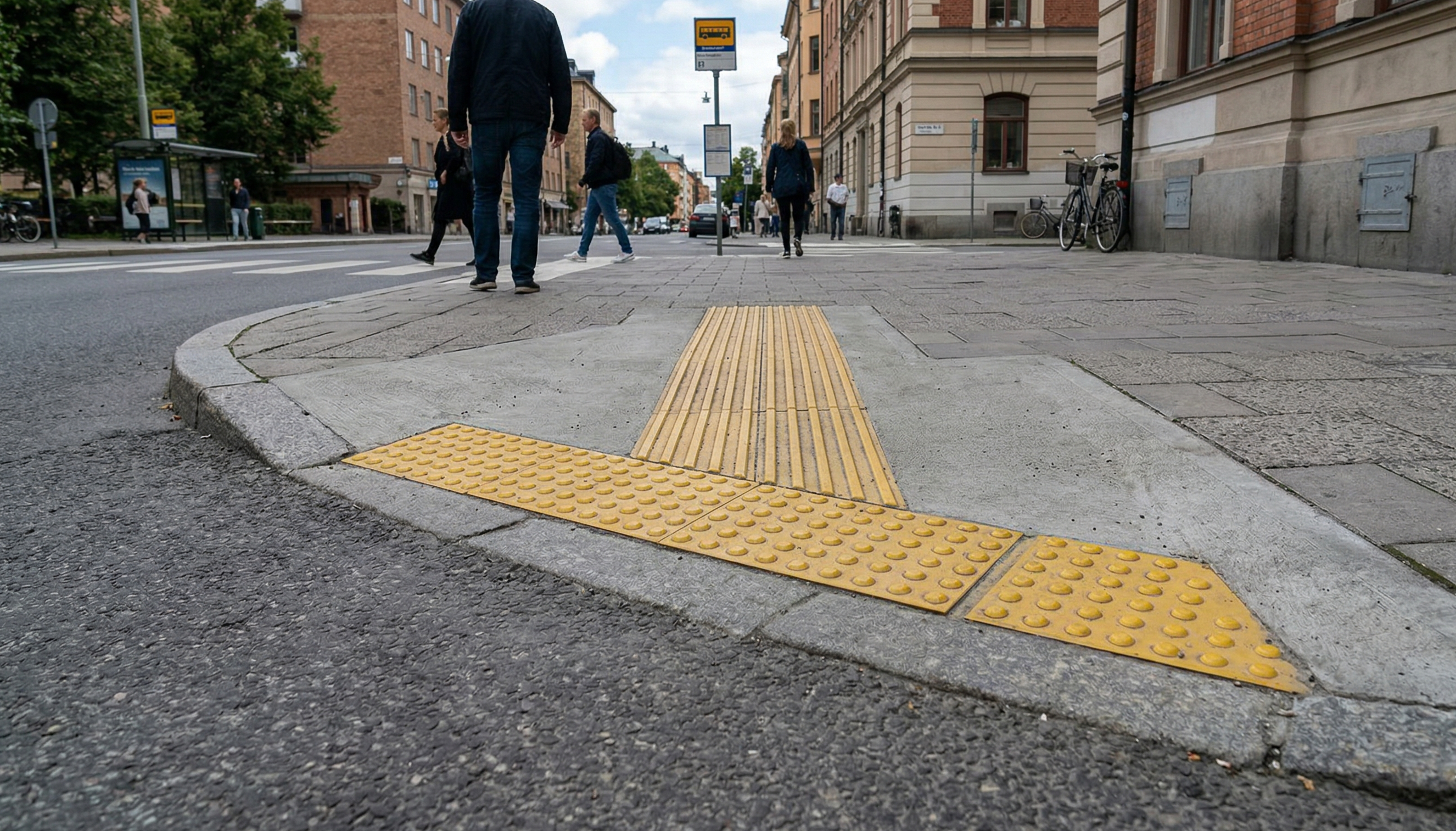 Image of a curb cut marking the transition between a street at sidewalk