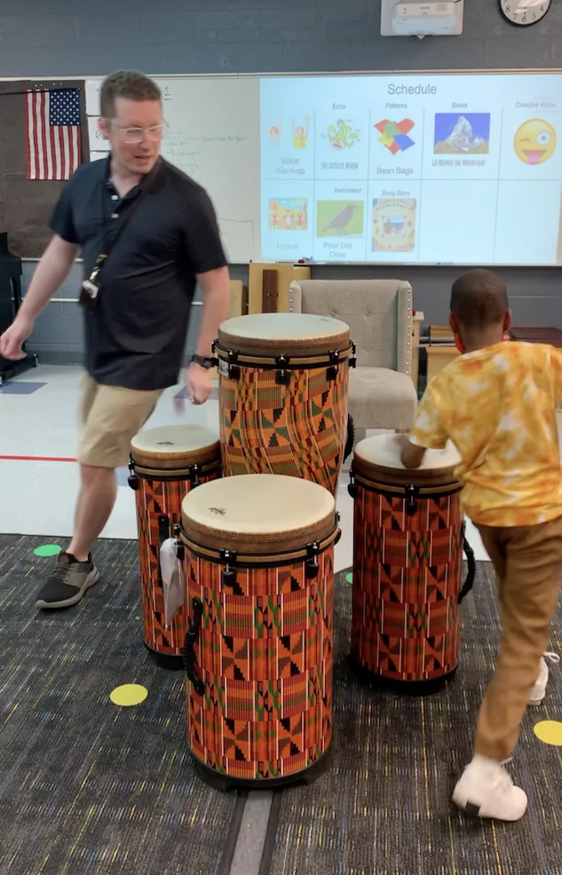 Dr. Bottorff and a student drumming while walking in a circle